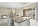 Kitchen island with sink, dishwasher, and breakfast bar at 17680 N 77Th Pl, Scottsdale, AZ 85255