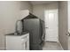 Laundry room with a utility sink and modern appliances at 17680 N 77Th Pl, Scottsdale, AZ 85255