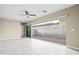 Bright living room with tiled floors and sliding glass doors leading to a patio at 17680 N 77Th Pl, Scottsdale, AZ 85255