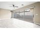 Bright living room with tiled floors and sliding glass doors leading to a patio at 17680 N 77Th Pl, Scottsdale, AZ 85255