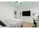 Bedroom with bed, television, and desk with an overhead light-blue colored tray ceiling at 1885 W Dion Dr, Phoenix, AZ 85086