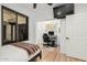 Well-lit bedroom featuring a bed, TV, and desk area for a functional living space at 1885 W Dion Dr, Phoenix, AZ 85086