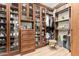 Large walk-in closet with custom wooden shelves, glass doors, and ample storage space for clothing and accessories at 1885 W Dion Dr, Phoenix, AZ 85086