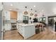 Bright kitchen featuring a large island with white countertops and shaker cabinets, stainless steel appliances, and modern pendant lighting at 1885 W Dion Dr, Phoenix, AZ 85086