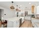 Bright kitchen with white cabinets, stainless steel appliances, a large island, and modern pendant lighting at 1885 W Dion Dr, Phoenix, AZ 85086