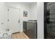 A practical laundry room features modern appliances, a stylish basket, and bright lighting at 1885 W Dion Dr, Phoenix, AZ 85086