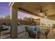 Inviting covered patio featuring seating, fan, and an outdoor view of the refreshing pool at 1885 W Dion Dr, Phoenix, AZ 85086