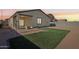 Artificial turf backyard with a covered patio at 19371 N Nocera Rd, Maricopa, AZ 85138