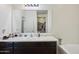 Bathroom with dark wood vanity and a large mirror at 19371 N Nocera Rd, Maricopa, AZ 85138