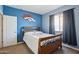 Blue bedroom with double bed and Broncos wall art at 19371 N Nocera Rd, Maricopa, AZ 85138