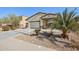 One-story house with a two-car garage and a palm tree at 19371 N Nocera Rd, Maricopa, AZ 85138