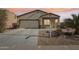 Exterior view of a charming house with a two-car garage at 19371 N Nocera Rd, Maricopa, AZ 85138