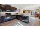 Dark wood cabinets and black appliances in this kitchen at 19371 N Nocera Rd, Maricopa, AZ 85138