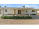 Home's back exterior showcasing a patio, landscaping, and a gravel yard at 19619 N Signal Butte Cir, Sun City, AZ 85373