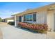 Front entry with flowering bushes and a concrete walkway at 19619 N Signal Butte Cir, Sun City, AZ 85373