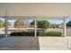 Covered patio with view of a desert landscape with mature citrus trees at 19619 N Signal Butte Cir, Sun City, AZ 85373