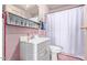 Pink tiled bathroom with shower/tub combo, vanity, and storage at 2041 N 23Rd St, Phoenix, AZ 85006