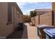 Small paved backyard with a brick wall, small plants, and AC unit at 21081 E Via De Olivos --, Queen Creek, AZ 85142