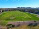 Expansive park offers recreational space with sports fields and lush greenery, set against a scenic mountain backdrop at 21081 E Via De Olivos --, Queen Creek, AZ 85142