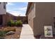 Landscaped side yard with a walkway and a welcome sign at 21081 E Via De Olivos --, Queen Creek, AZ 85142