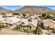 Aerial view showcasing house, putting green, palm trees, and mountain backdrop at 21964 N 59Th Ln, Glendale, AZ 85310