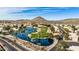 Aerial view of community with lake, golf course, and surrounding houses at 21964 N 59Th Ln, Glendale, AZ 85310