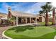 Putting green and patio with pergola in the backyard at 21964 N 59Th Ln, Glendale, AZ 85310