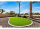 Landscaped backyard featuring a putting green at 21964 N 59Th Ln, Glendale, AZ 85310