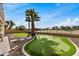 Backyard oasis with putting green and palm trees at 21964 N 59Th Ln, Glendale, AZ 85310