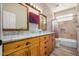 Bathroom with double vanity, granite countertop, and large tile shower at 21964 N 59Th Ln, Glendale, AZ 85310