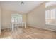 Bright dining room with wood-look floors and a table for casual dining at 21964 N 59Th Ln, Glendale, AZ 85310