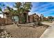 House with desert landscaping and large tree at 21964 N 59Th Ln, Glendale, AZ 85310