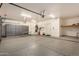 Garage with storage cabinets, sink, and epoxy flooring at 21964 N 59Th Ln, Glendale, AZ 85310