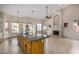 Open kitchen with island, stainless steel appliances, and views to Gathering room at 21964 N 59Th Ln, Glendale, AZ 85310