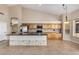 Spacious kitchen with island, stainless steel appliances, and wood cabinets at 21964 N 59Th Ln, Glendale, AZ 85310