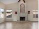 Living room featuring a tile fireplace and large windows at 21964 N 59Th Ln, Glendale, AZ 85310