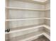 Walk-in pantry with ample shelving at 21964 N 59Th Ln, Glendale, AZ 85310