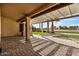 Spacious patio with pergola, overlooking a putting green and landscaped yard at 21964 N 59Th Ln, Glendale, AZ 85310