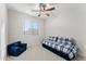 Bedroom with daybed, ceiling fan, and a navy chair at 23059 E Pummelos Rd, Queen Creek, AZ 85142