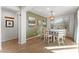 Bright dining room features a round table with chairs and a modern light fixture at 23059 E Pummelos Rd, Queen Creek, AZ 85142