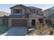 Two-story house with brown garage door and Spanish tile roof at 23059 E Pummelos Rd, Queen Creek, AZ 85142