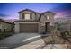 Two-story house with attached garage and landscaped yard at 23059 E Pummelos Rd, Queen Creek, AZ 85142