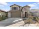 Two-story home with a two-car garage and landscaping at 23059 E Pummelos Rd, Queen Creek, AZ 85142