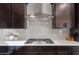 Modern kitchen with gas cooktop and white hexagonal backsplash at 23059 E Pummelos Rd, Queen Creek, AZ 85142