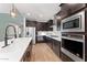 Modern kitchen with stainless steel appliances and white quartz countertops at 23059 E Pummelos Rd, Queen Creek, AZ 85142