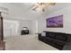 Spacious loft sitting area with sectional sofa and mountain art at 23059 E Pummelos Rd, Queen Creek, AZ 85142