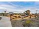 Charming playground with a playhouse and farm equipment at 23059 E Pummelos Rd, Queen Creek, AZ 85142