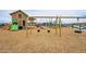 Play area with swings and playhouse structure at 23059 E Pummelos Rd, Queen Creek, AZ 85142