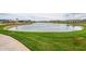 Curved pond with grassy areas and walking path at 23059 E Pummelos Rd, Queen Creek, AZ 85142