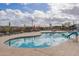 Freeform community pool with lounge chairs at 23059 E Pummelos Rd, Queen Creek, AZ 85142